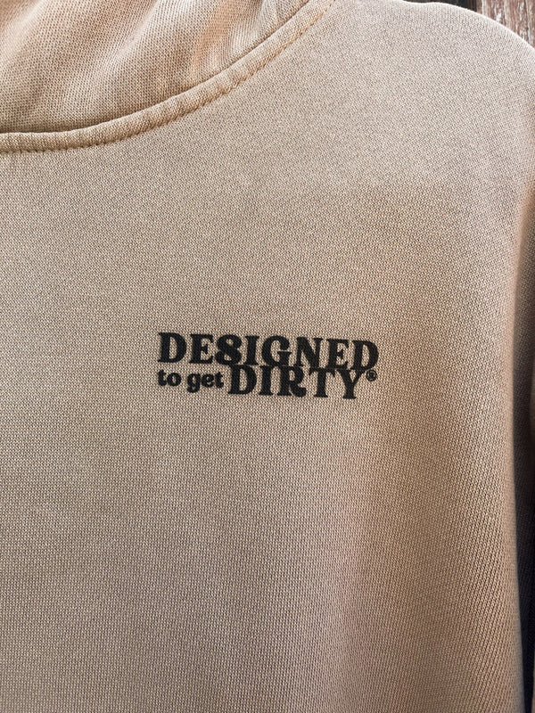 Tan oversized hoodie with "Designed to get dirty®" printed in black on the front left chest