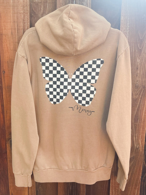 Tan oversized hoodie with a black and white checkered butterfly on the back 