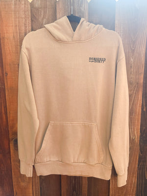 Tan oversized hoodie with "Designed to get dirty®" printed in black on the front left chest