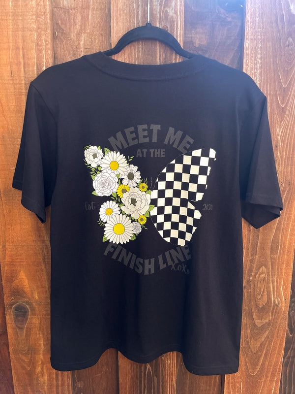 Black youth shirt with a butterfly on the back. One wing is flowers and the other is black and white checkers. It says Meet Me at the Finish Line xoxo on it.