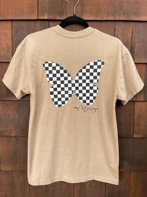 Sand-colored unisex shirt with a black and white checkered butterfly on the back