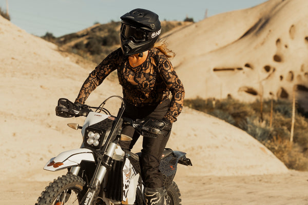 Person riding a dirt bike on a sandy trail