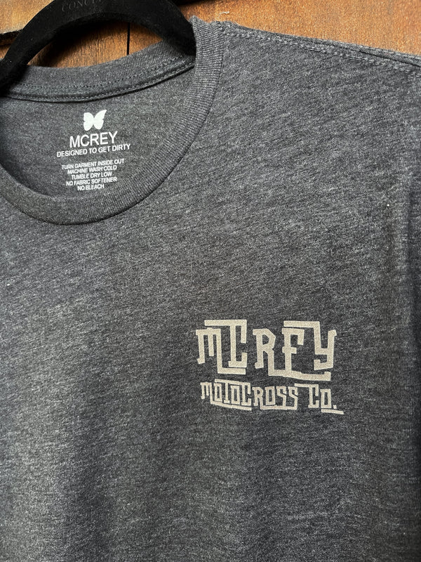 Charcoal grey unisex long sleeve. It features the words "MCREY MOTOCROSS CO." on the front left chest