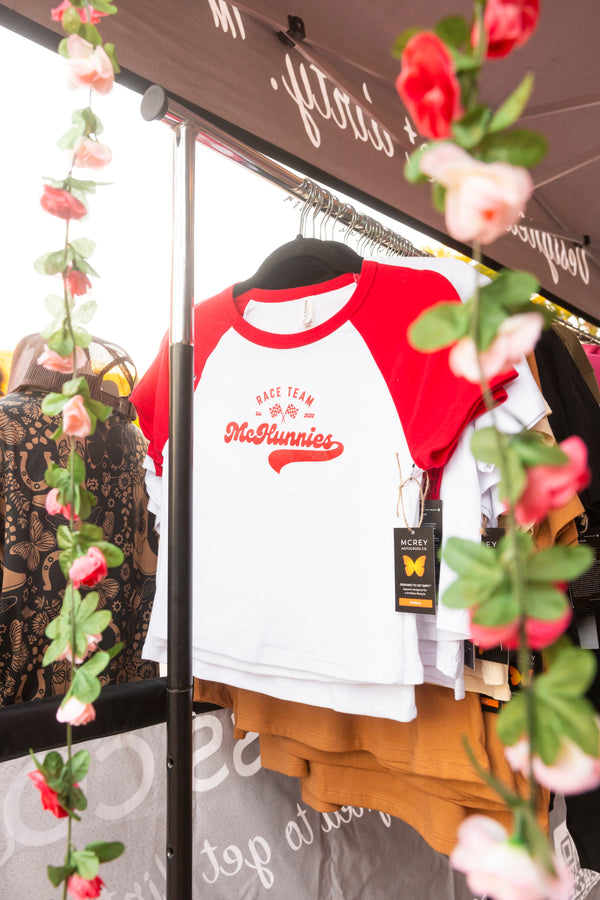 Red and white shirt with 'McHunnies Race Team' surrounded by floral decorations.