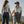 Load image into Gallery viewer, Two women holding hands in a desert landscape with mountains in the background.
