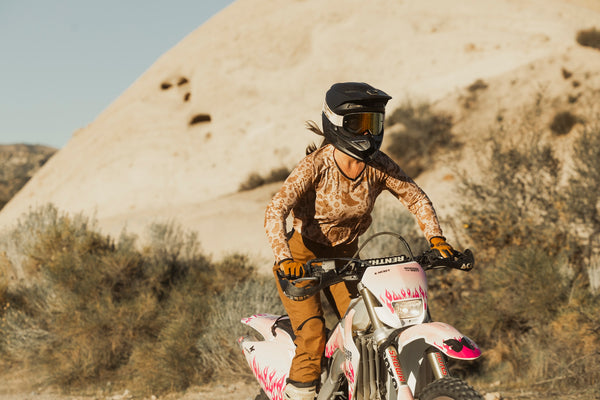 Person riding a dirt bike in a desert landscape