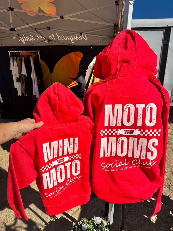 Matching mom and youth red hoodies that say 'Moto Moms Social Club' and 'Mini Moto Social Club' on the back.