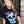 Load image into Gallery viewer, Woman wearing a black shirt with a skull surrounded by flowers and butterflies on the front.
