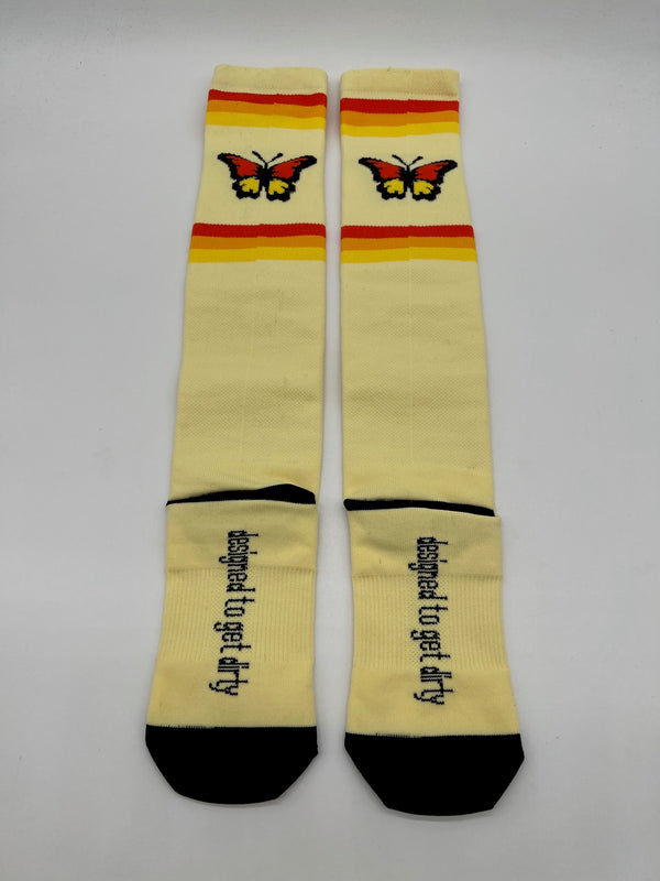 Pair of women's dirt bike socks in yellow with butterflies on them