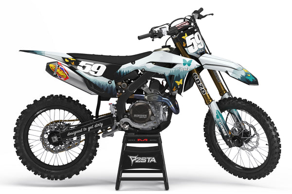 Honda CRF 250X with a forest dirt bike graphics kit. Turquoise pine trees and gold glitter butterflies.