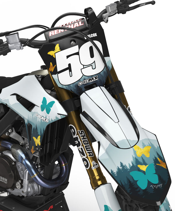 Honda CRF 250X with a forest dirt bike graphics kit. Turquoise pine trees and gold glitter butterflies.