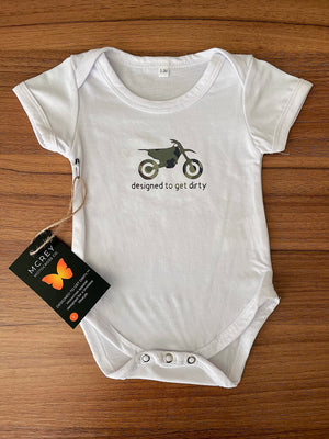 White baby onesie with a camo design on the front. A dirt bike with the words designed to get dirty underneath it
