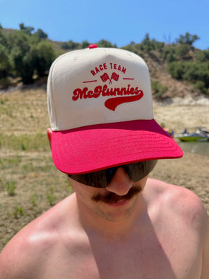 Man wearing a tan and red unisex snapback with the words 'McHunnies Race Team' stitched on the front with two checkered flags