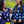 Cargar imagen en el visor de la galería, A woman and a girl laughing at each other. They are wearing matching dirt bike jerseys that are navy blue with white daisies on them.
