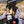 Load image into Gallery viewer, Woman wearing a white jersey with grey bull skulls on it, Heat Wave goggles, and a black pack. She is sitting on her dirt bike in the mountains.
