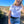 Load image into Gallery viewer, Blonde woman wearing a white crop shirt with black writing that says designed to get dirty in the middle of a field
