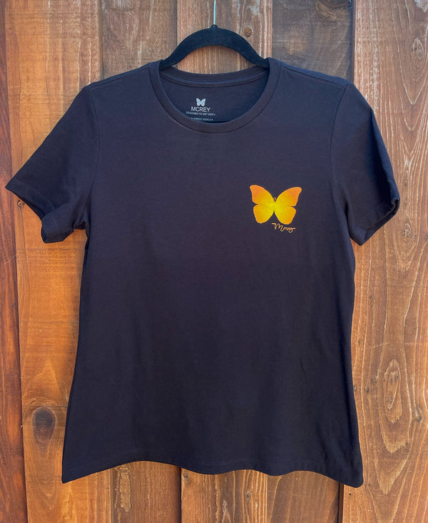 Front of a women's black t-shirt with an orange and yellow butterfly on the front left chest.