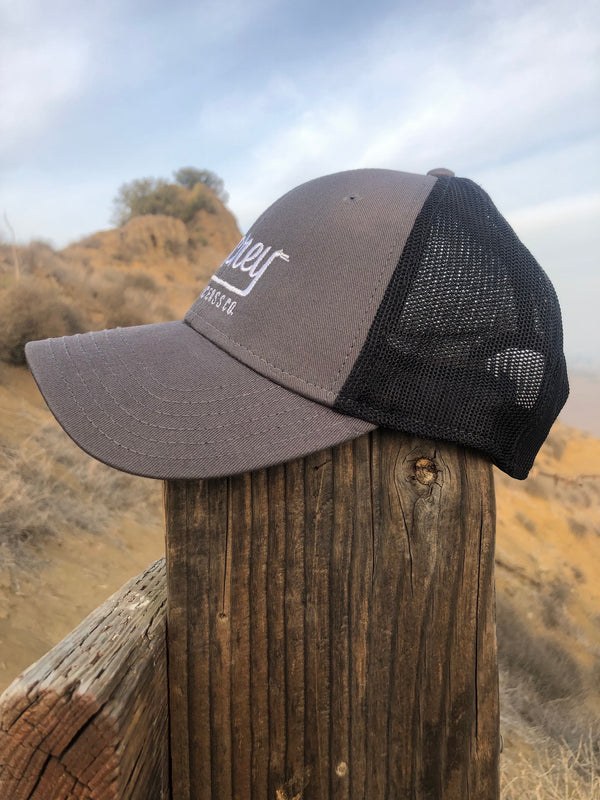 Grey baseball cap with white MCREY MX logo and black mesh. Adjustable hat.