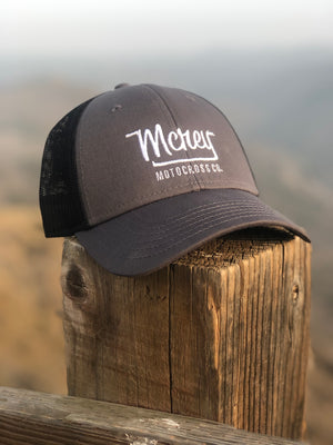 Grey baseball cap with white MCREY MX logo and black mesh. Adjustable hat.