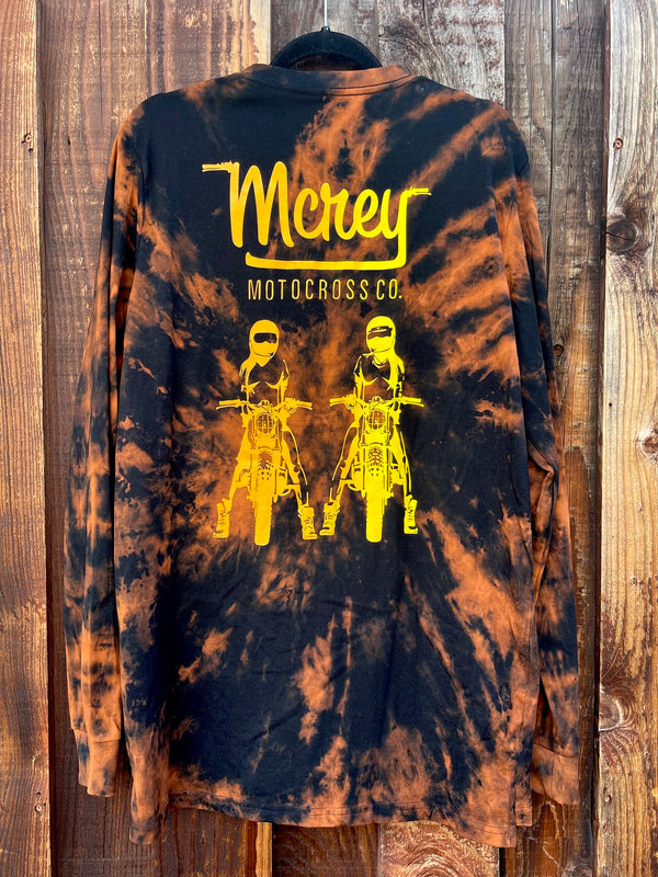 Black long sleeve tie-dye shirt with MCREY MOTOCROSS CO logo on the back above a graphic of two girls sitting on dirt bikes