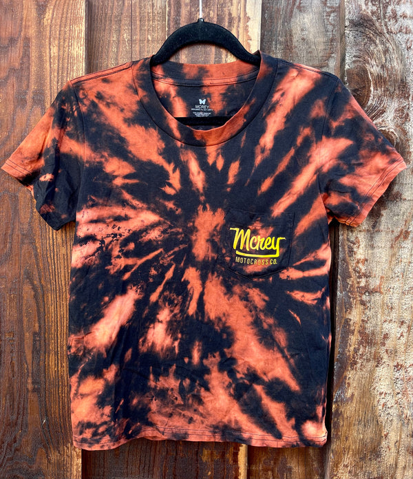 Women's tie-dyed black tee. On the back is MCREY MOTOCROSS CO logo on a small pocket.
