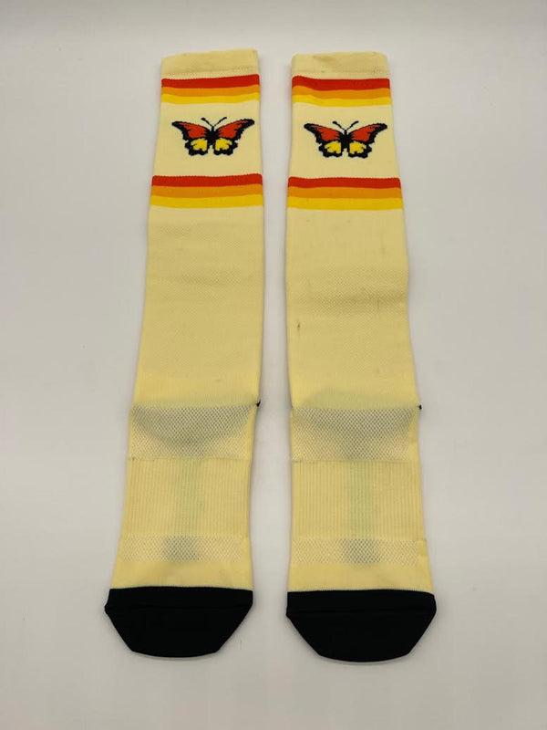 Women's knee-high performance moto socks with retro 70's vibes and butterflies